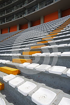 Rows of empty orange and white seats in the sports complex of the Estadio Nacional - Soccer Stadium - in Lima Peru photo