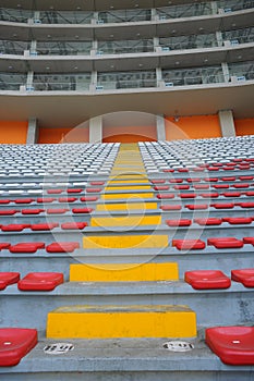 Rows of empty orange and white seats in the sports complex of the Estadio Nacional - Soccer Stadium - in Lima Peru photo