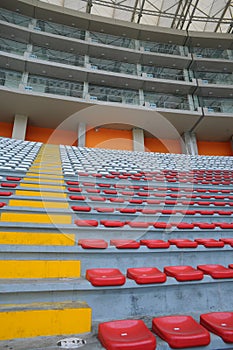 Rows of empty orange and white seats in the sports complex of the Estadio Nacional - Soccer Stadium - in Lima Peru