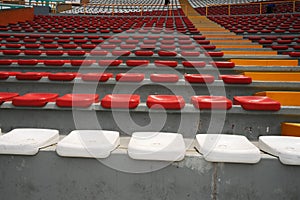 Rows of empty orange and white seats in the sports complex of the Estadio Nacional - Soccer Stadium - in Lima Peru photo