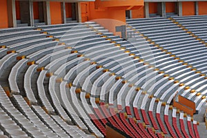 Rows of empty orange and white seats in the sports complex of the Estadio Nacional - Soccer Stadium - in Lima Peru photo