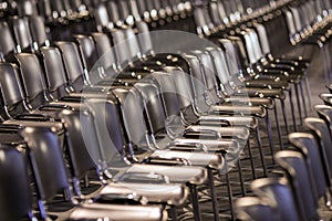 Rows of empty plastic seats in an empty conference room