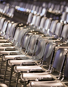 Rows of empty plastic seats in an empty conference room