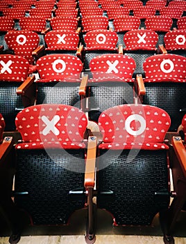 Rows of empty red cinema chairs in a theatre during the period of the covid-19, corona virus. Social distancing