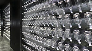 Rows of empty wine bottles in a vinotheque. Background. Copy space. .Mobile photo.Rows of empty wine bottles in a vinotheque. photo