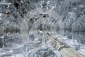 Rows of empty wine glasses close up. Glass goblets on the white table