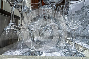 Rows of empty wine glasses close up. Glass goblets on the white table.