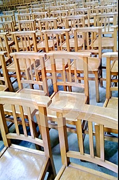 Rows of empty wooden chairs