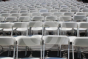 Rows of folding white chairs