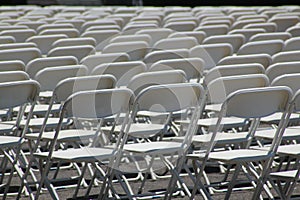Rows of folding white chairs