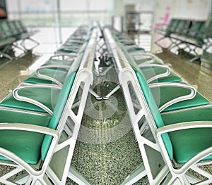 Rows of green chairs for passengers.