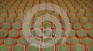 rows of green chairs in a theater auditorium