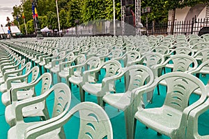 Rows of green plastic chairs outdoor celebration event