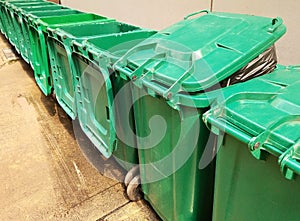 Rows of green plastic recycling bin.