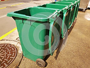 Rows of green plastic recycling bin.