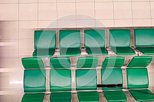 Rows of green seats for passengers look empty