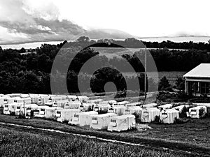 Rows of individual huts for housing infant bottle calves at a dairy farm.