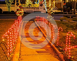 Rows of lit candy canes lighting village sidewalk