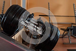 Rows of metal dumbbells on rack in the gym / sport club. Weight Training Equipment. - Image