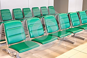 Rows of modern green chairs in waiting room
