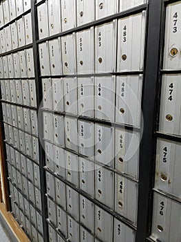 Rows of numbered metal post office mailboxes