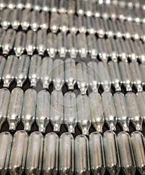 Rows of empty nitrous oxide cannisters / cream puff chargers: used as a legal high