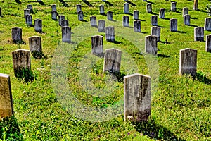 Rows of old, marble, unmarked grave headstones