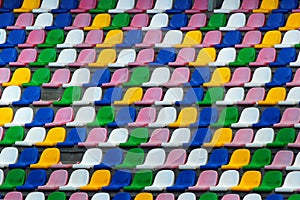 Rows of old plastic colorful seats at a stadium