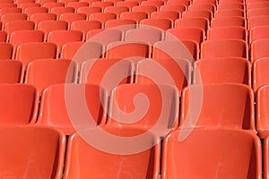 Rows of orange seats for spectators of sporting events