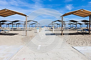 Rows of the palm leaf sun shades on the beach