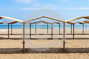 Rows of the palm leaf sun shades on the beach