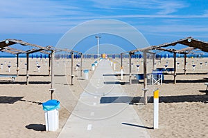 Rows of the palm leaf sun shades on the beach