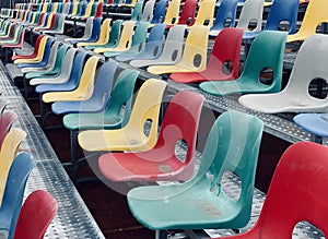 Rows of plastic colorful seats at a stadium