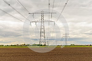 Rows of power pylons in a rural landscape