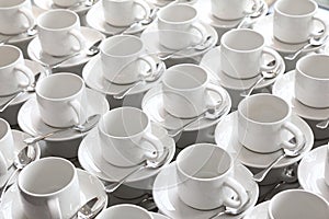 Rows of pure cup and saucer with teaspoon