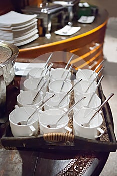 Rows of pure white cup and saucer with teaspoon