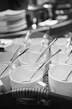 Rows of pure white cup and saucer with teaspoon