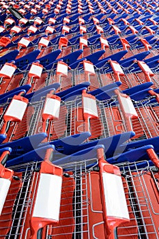 Rows of red and blue shopping carts