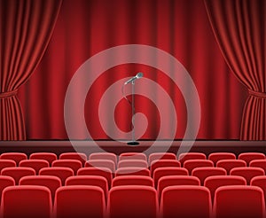 Rows of red cinema or theater seats in front of show stage