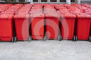 Rows of red hazardous waste bins are neatly placed backside of the field hospital waiting to be dispose hygienically photo