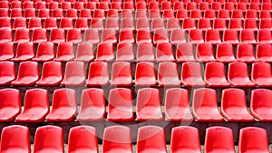 Rows of red plastic seats grandstand stadium