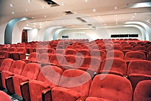 Rows of red seats in an auditorium