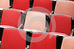 Rows of red theater seats in sn auditorium