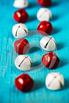 2 rows of red and white jingle bells on blue background