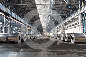 Rows of rolls of aluminum lie in production shop photo