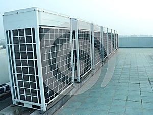 Rows of rooftop HVACs on the rooftop of an office tower. VRF air conditioner for commercial buildings