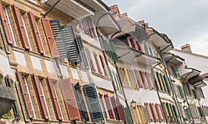 Rows upon rows of old house fronts with pretty windows and wooden shutters in many different colors