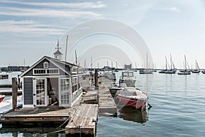 Rows of sailing boats and luxury yachts anchored in Boston harbor pier Names and trademark are revomed.