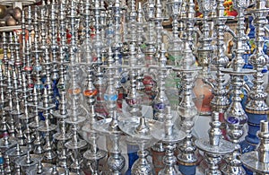 Rows of shisha water pipes in an egyptian market stall