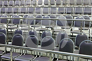 Rows of simple chairs with handrails in modern photo